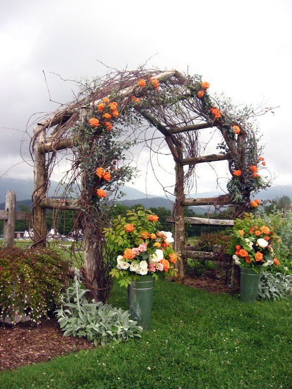 Orange Country Garden Wedding Arbor – shared in a roundup post on Rustic Wedding Chic