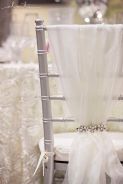Sparkly Tulle and Pearl Chair Décor – shared in a roundup post on Want That Wedding