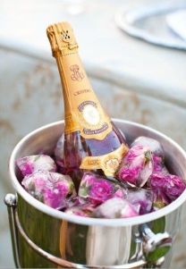 Champagne Bottle Display with Frozen Flowers in Ice – shared in a round up post on OMG Lifestyle Blog