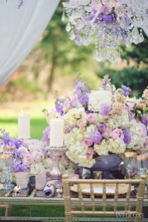 White and Lilac Purple Rustic Centerpiece with Fresh Flowers and Candles – shared on WedLuxe