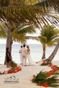 Beach Wedding Aisle with Palm Leaves and Vibrant Flowers – shared by Olivera Rusu Photography