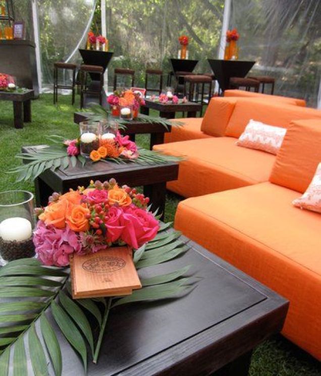 Modern Orange Outdoor Lounge with Dark Wood and Palm Leaf Accents