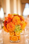 Vibrant Orange Flower Centerpiece with Orange Slices