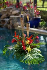 Floating Pool Décor with Tropical Foliage and Tiki Torches – featured on Jet Fete