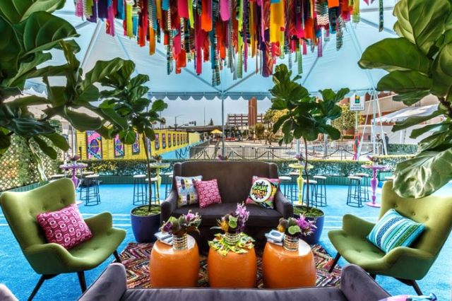 Vibrant Reception Lounge with Hanging Ribbon and Streamer Installation – featured on BizBash